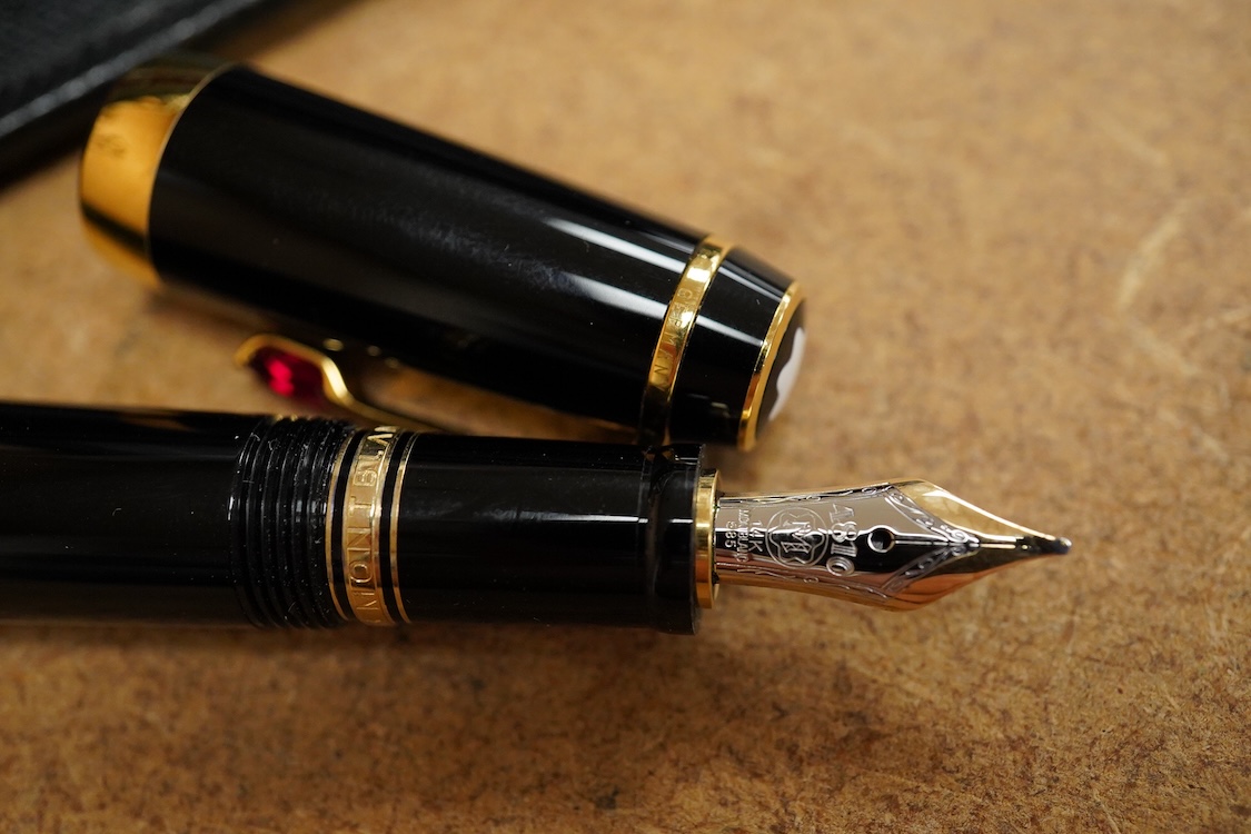 A leather cased Mont Blanc pen with retractable nib and decorative jewelled clip, 11cm long